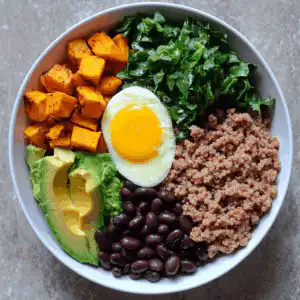 served high protein breakfast bowl with eggs and vegetables