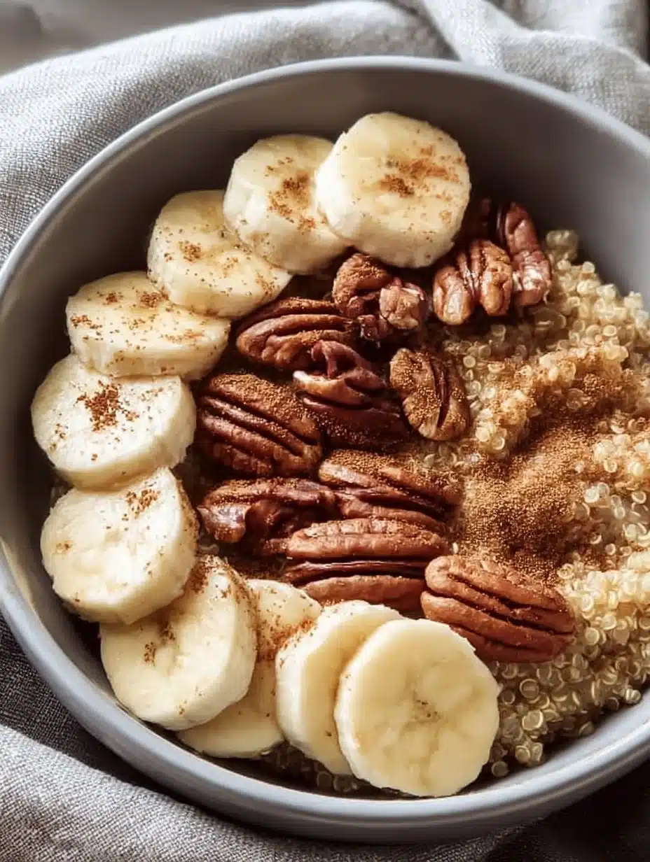 Bowl of nutritious quinoa oatmeal topped with fresh fruits and nuts.