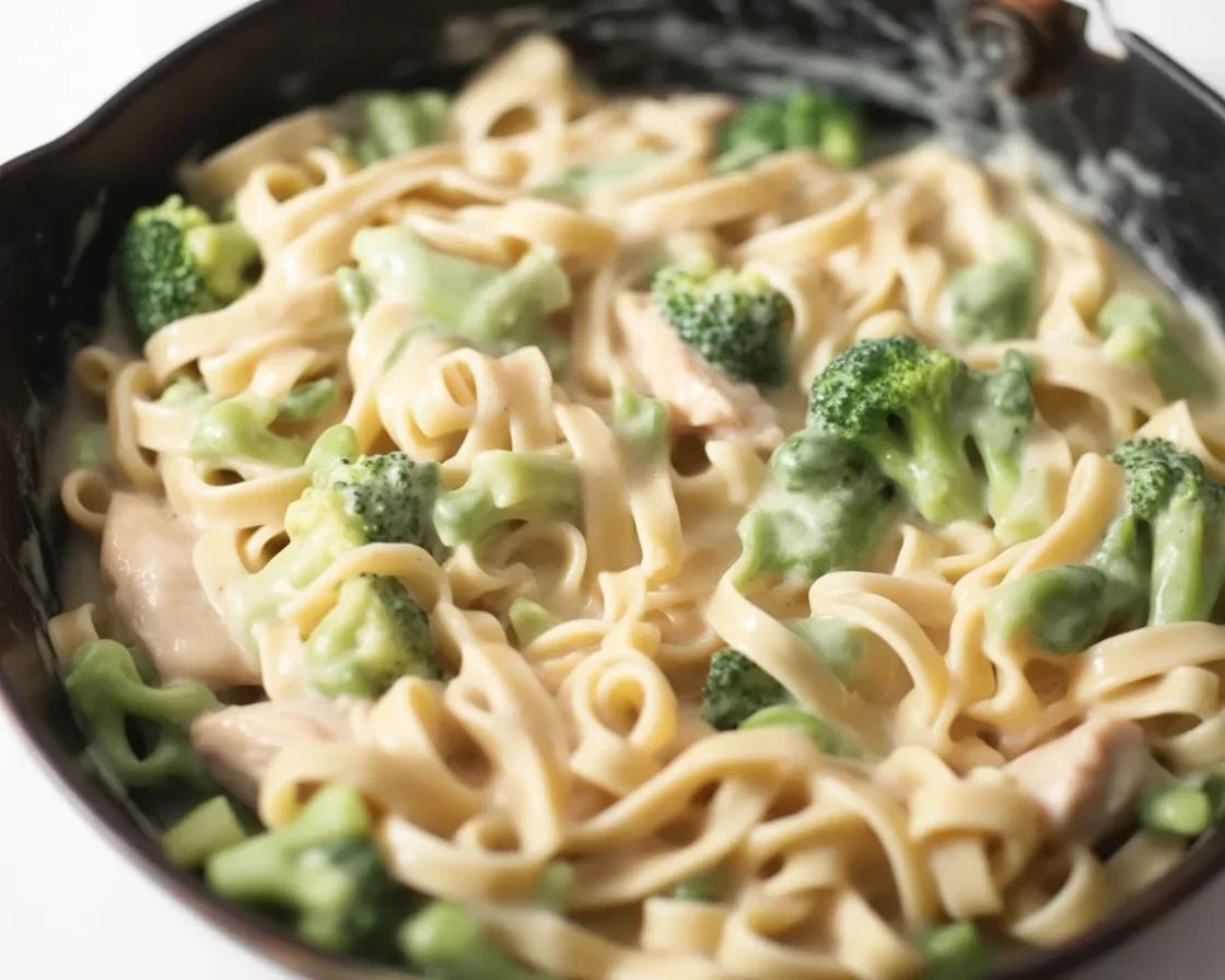 Creamy Chicken & Broccoli Fettuccine Alfredo dish with parmesan cheese garnish
