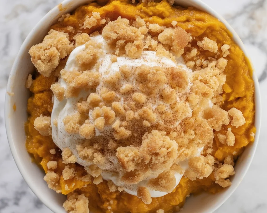 Delicious Healthy Pumpkin Mug Cake topped with cinnamon and pumpkin seeds in a cozy mug.