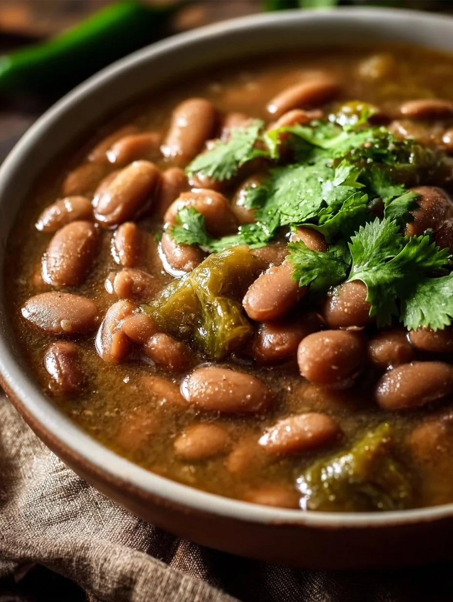 Slow cooker pinto beans with green chile and beef in a bowl