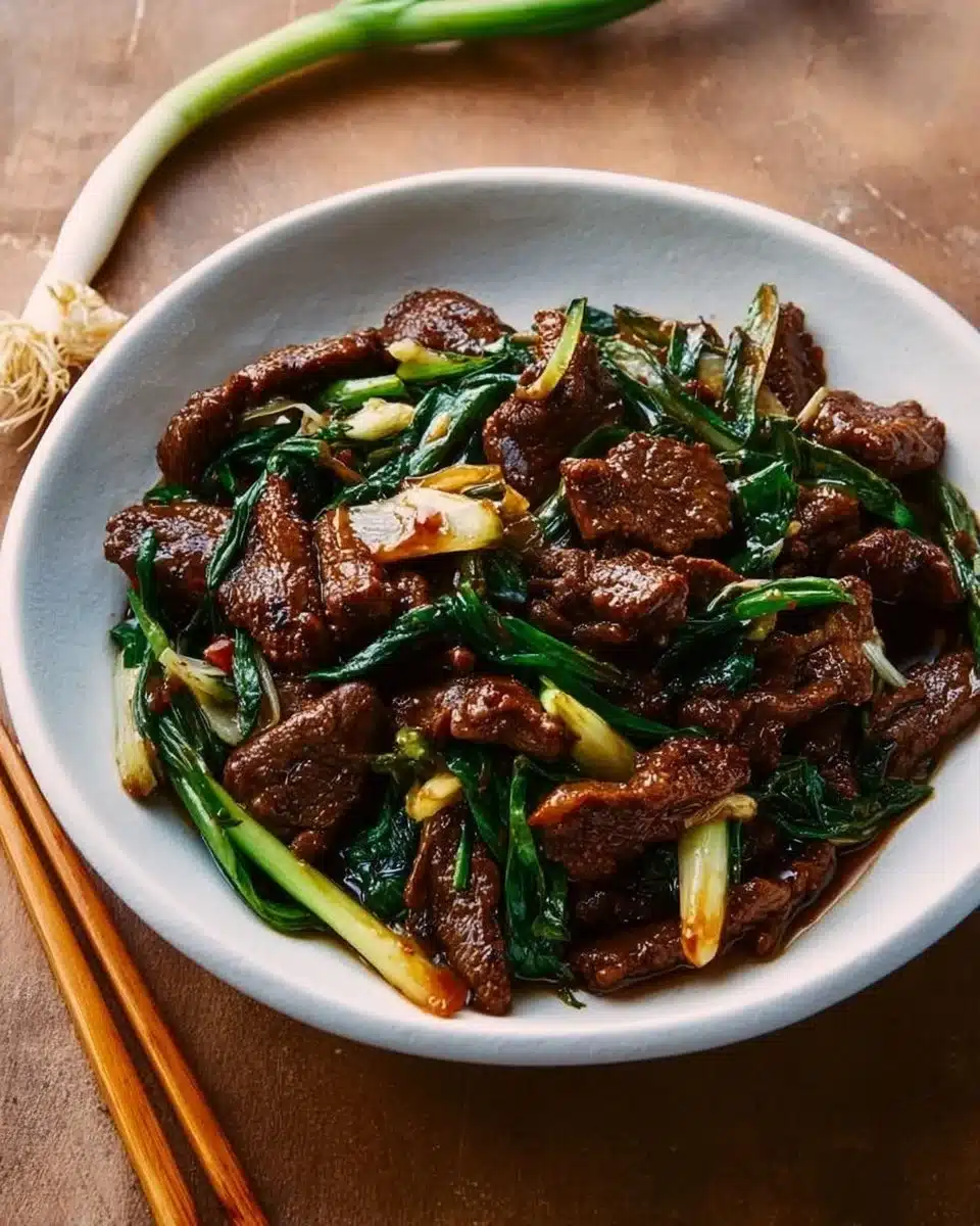 Delicious scallion beef stir-fry served with fresh vegetables and rice