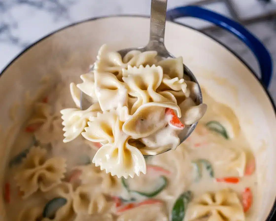 Creamy Chicken Alfredo Soup with chicken, herbs, and a rich alfredo broth.