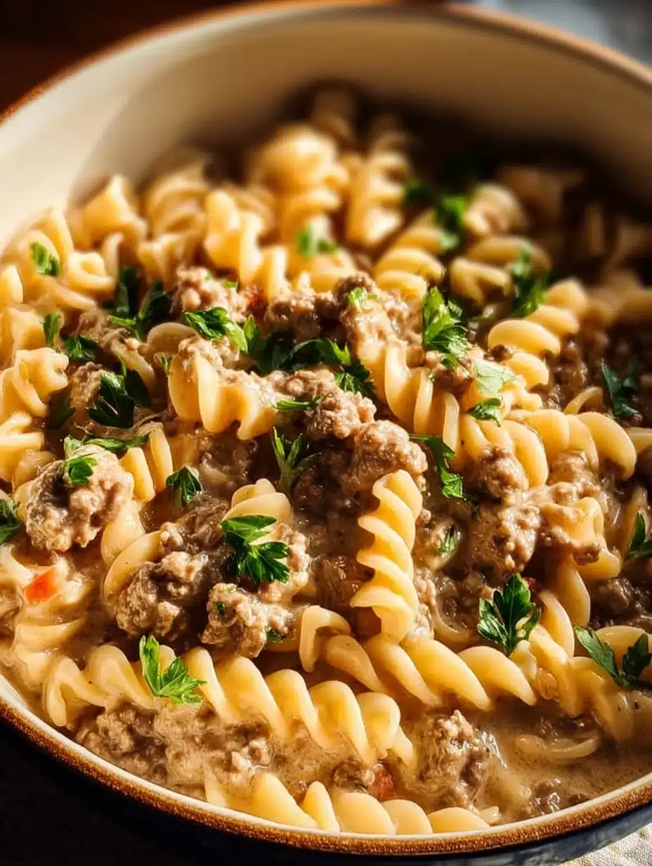 Creamy stovetop ground beef pasta served in a bowl with fresh herbs