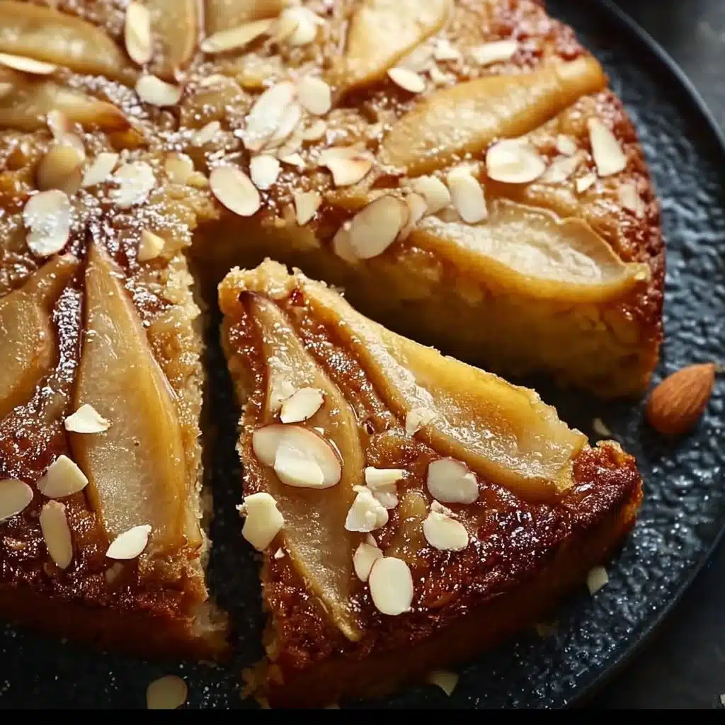 Sliced Pear Almond Cake garnished with almond slivers and fresh pears