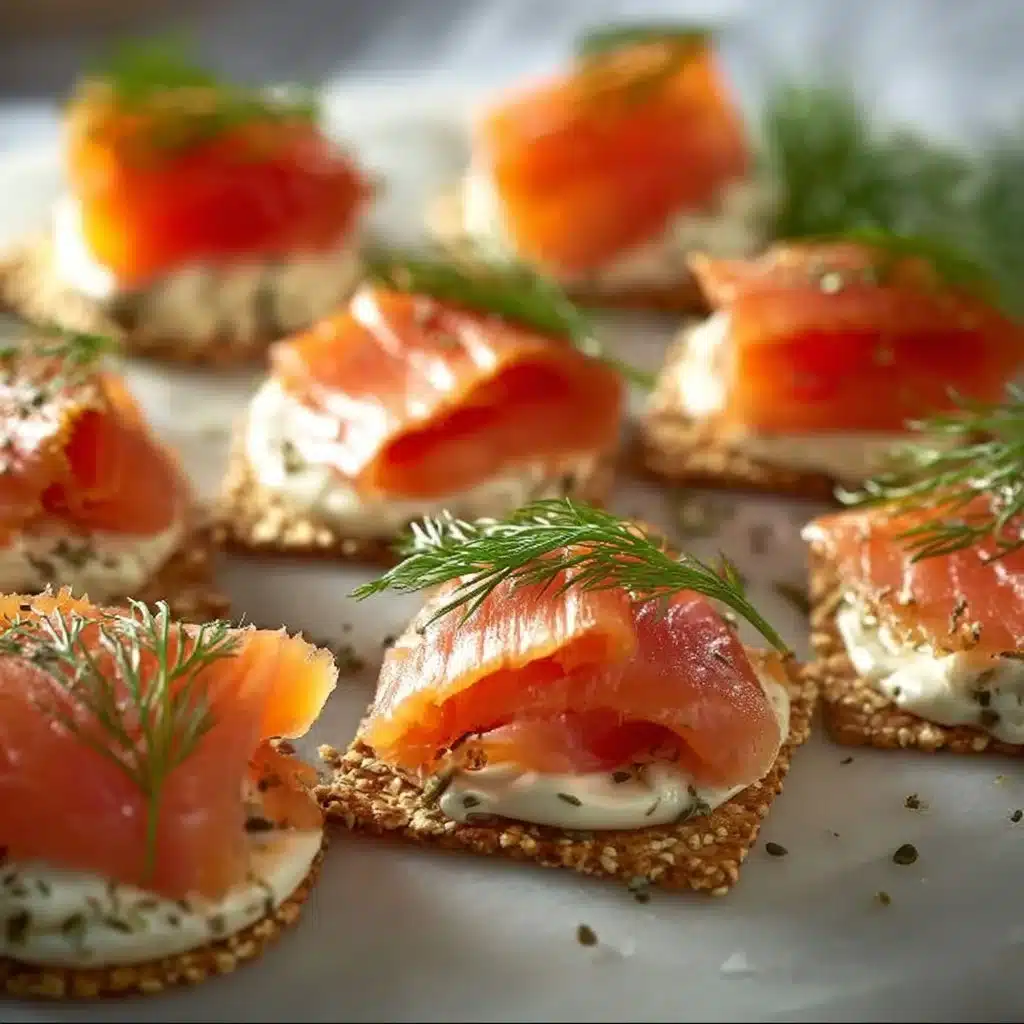 Platter of elegant smoked salmon canapés garnished with fresh herbs.