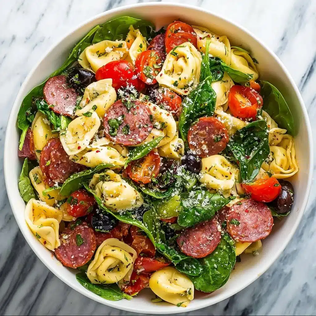 Colorful tortellini pasta salad with vegetables and dressing.