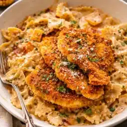 Cajun Chicken and Garlic Parmesan Linguine served in a creamy sauce with fresh herbs.