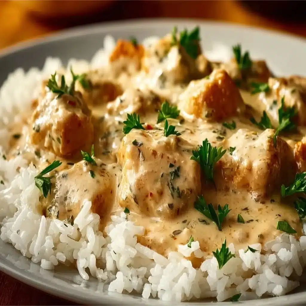 Delicious creamy smothered chicken served over rice