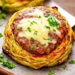 Oven-Baked Cabbage Burgers with juicy beef patties served on roasted cabbage slices.