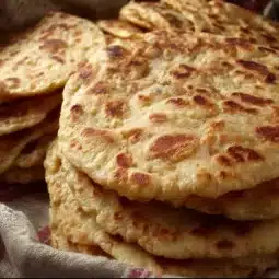 Delicious sweet griddle cakes stacked and drizzled with syrup