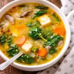Bowl of Anti-Inflammatory Miso Ginger Broth with Lemon, ginger, and vegetables.