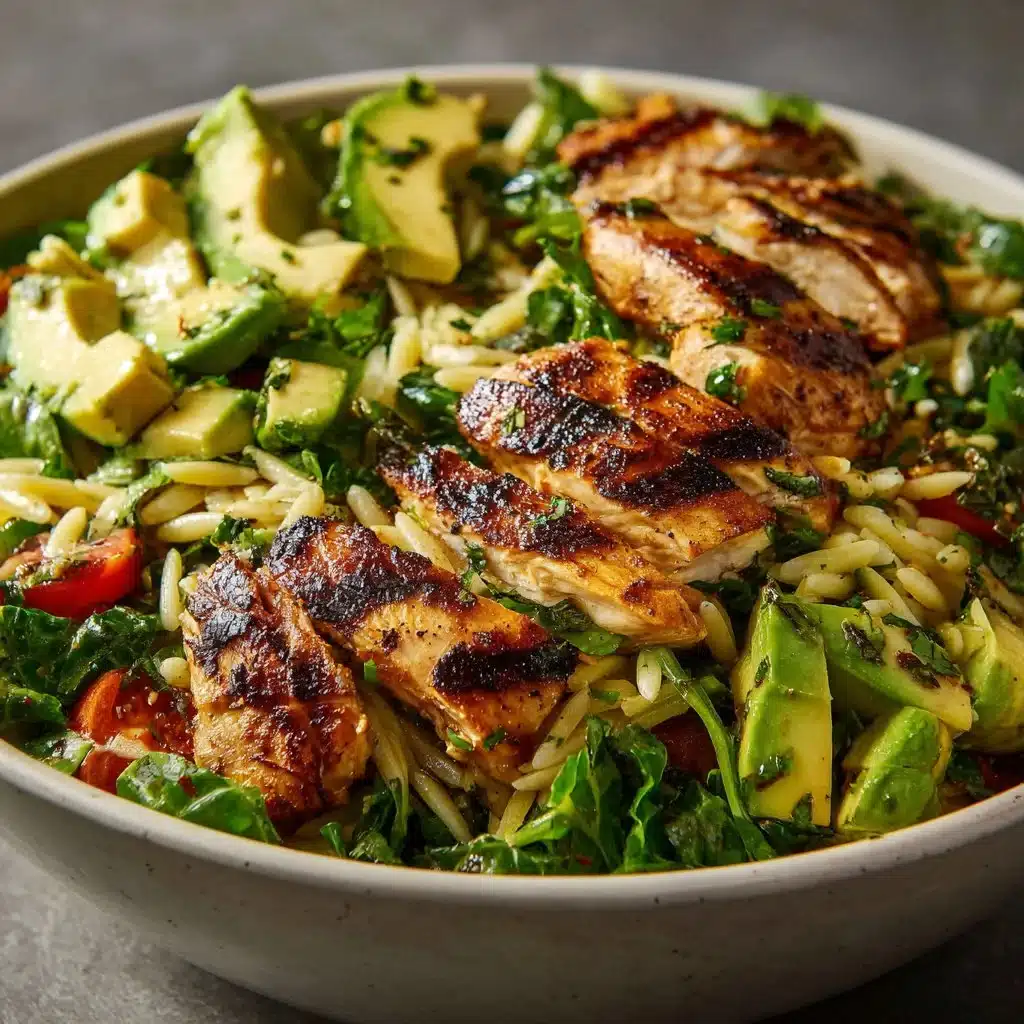Delicious grilled chicken orzo salad topped with fresh vegetables and herbs
