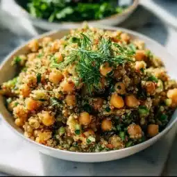 Lemon herb quinoa dish with chickpeas served on a rustic plate