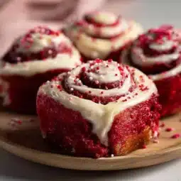 Delicious Red Velvet Valentine's Day cinnamon rolls topped with cream cheese frosting