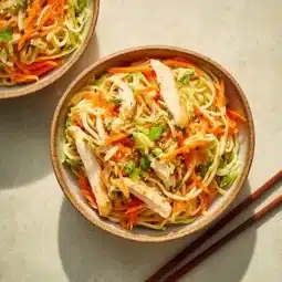 Delicious Classic Bang Bang Chicken Noodle Salad on a plate garnished with fresh vegetables