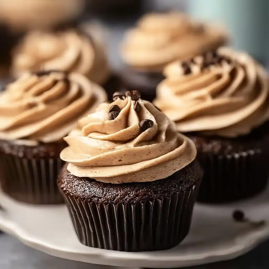 Delicious espresso cupcakes with coffee frosting on a rustic wooden table