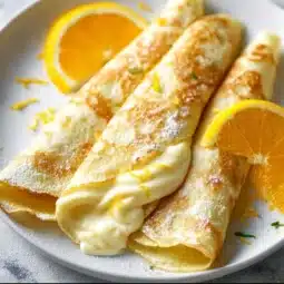 Honey-sweetened blender crepes with Greek yogurt lemon filling on a plate