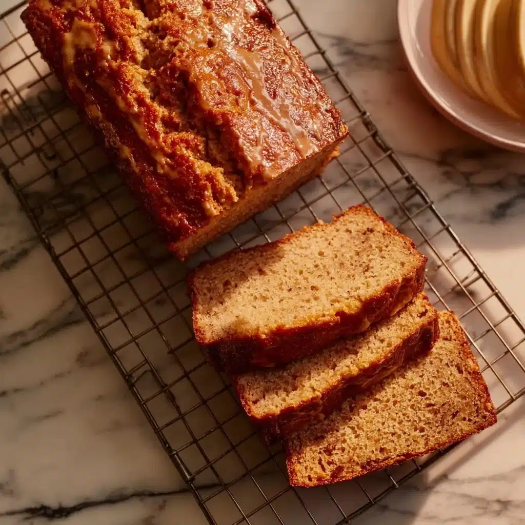 Delicious slice of Miso Maple Banana Bread with banana slices on top.