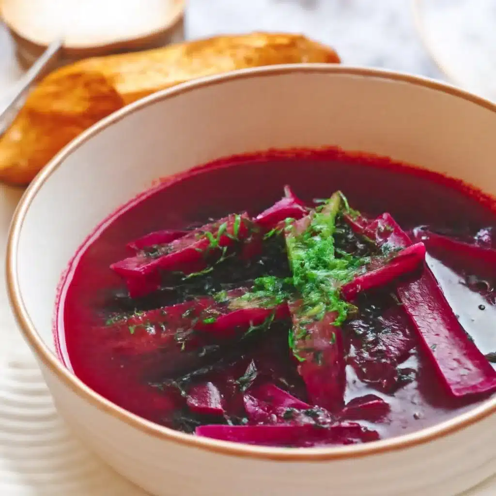 A bowl of vibrant Polish borscht soup made with beets and vegetables.