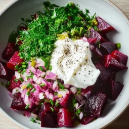 Beetroot salad dip with Greek yogurt served in a bowl with fresh vegetables.