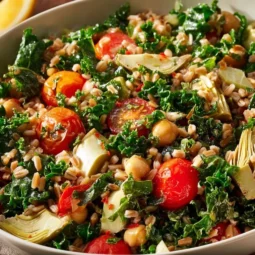 Healthy farro salad with fresh vegetables and dressing