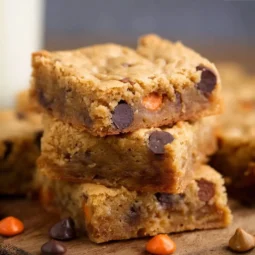 Delicious peanut butter blondies topped with Reese's Pieces