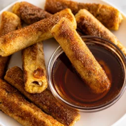 Delicious French Toast Roll Ups filled with cream cheese and berries, served for breakfast.