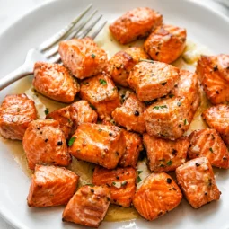 Crispy 10-Minute Air Fryer Garlic Butter Salmon Bites served with lemon.